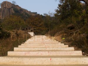 The well-maintained stairs will guide you to the top of the hillock.