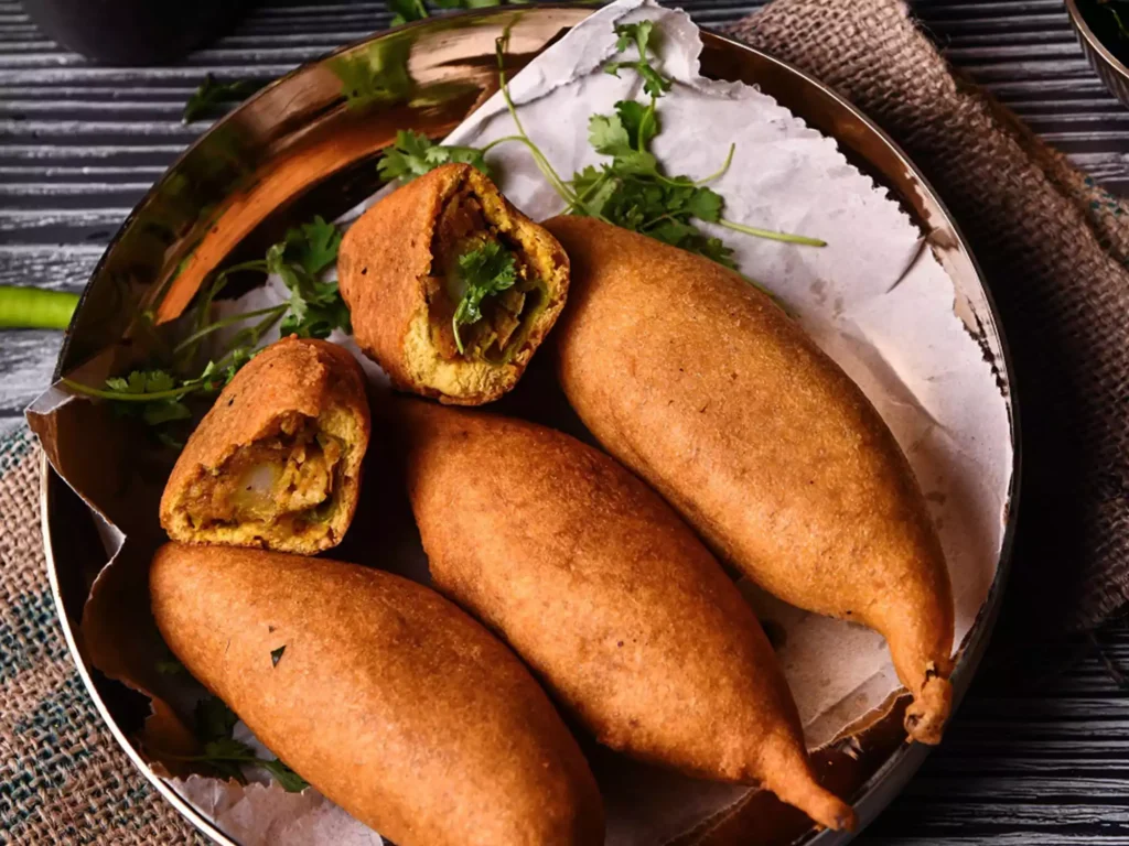 the street stalls sell long green chillies dipped in thick gram batter and deep fry them to make Mirch Bada